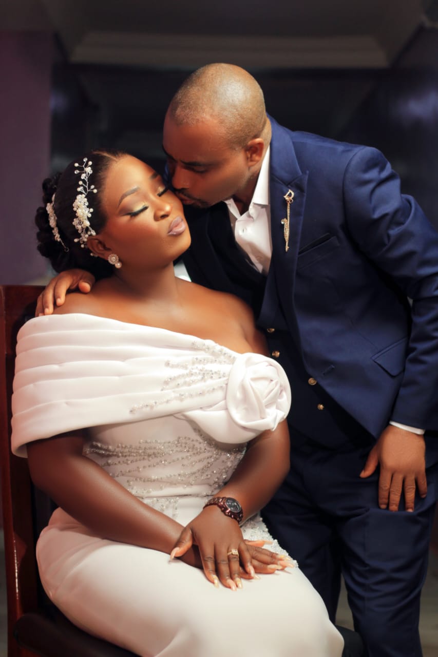 Groom kissing the bride's forehead