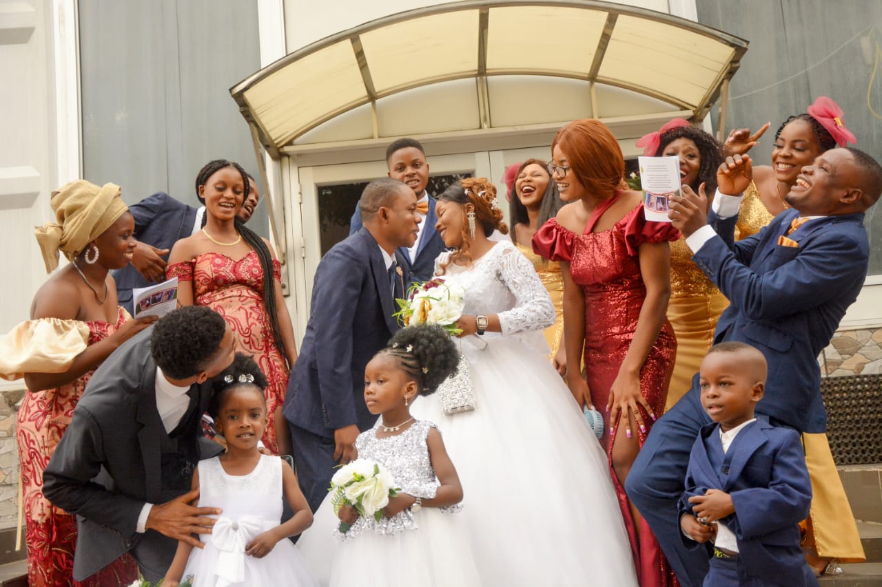 Bridal party laughing together outside the church